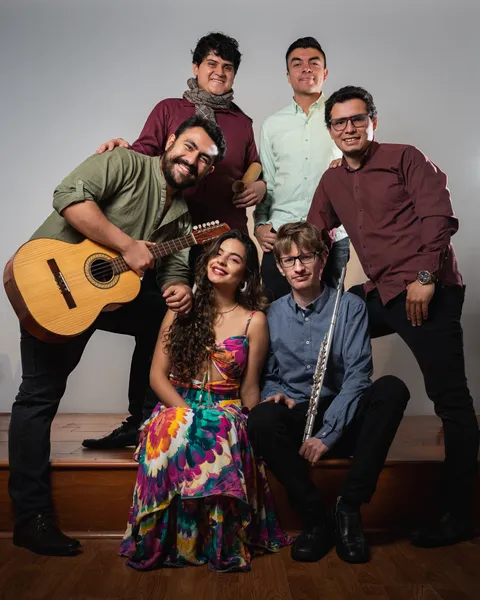Aroma Colombiano musicians posing together with their instruments